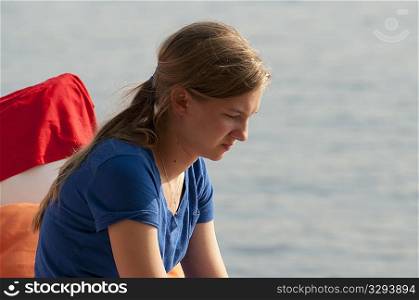 Profile of teenage girl looking downwards at Lake of the Woods, Ontario