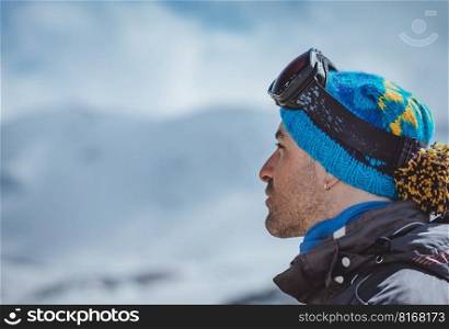Profile Portrait of a Man Enjoying Landscape. Winter Sport in the Mountains. Wintertime Vacation. Active People Lifestyle.. Portrait of an man Skier
