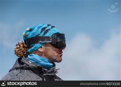 Profile Portrait of a Man Enjoying Landscape. Winter Sport in the Mountains. Wintertime Vacation. Active People Lifestyle.. Man Skier Enjoying Winter View