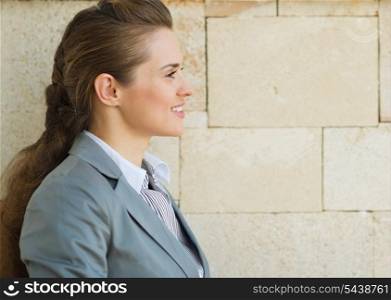 Profile portrait of happy business woman looking on copy space