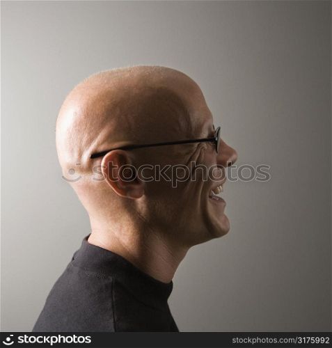 Profile portrait of mid-adult Caucasian male smiling.