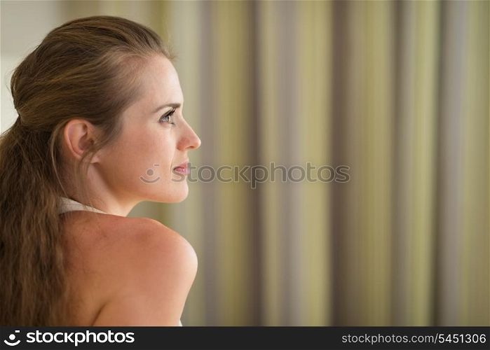 Profile portrait of thoughtful young woman looking on copy space