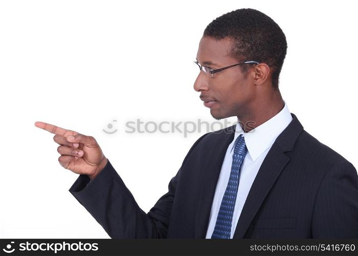Profile shot of a man in a suit pointing his finger