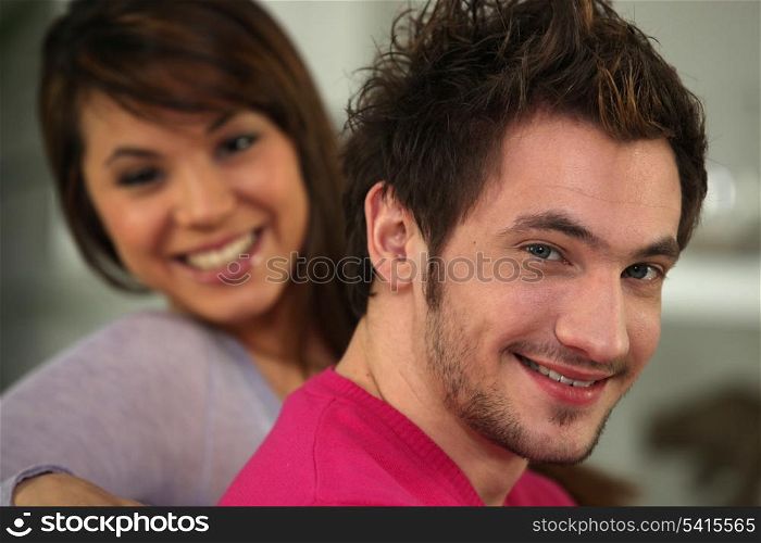 Profile shot of young couple relaxing on their sofa