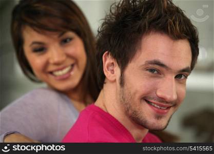 Profile shot of young couple relaxing on their sofa