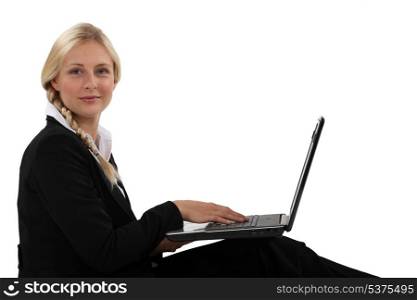 Profile view of blond office worker with laptop