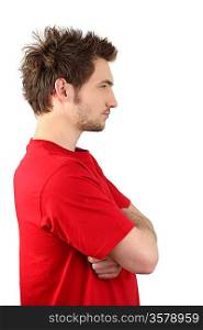Profile view of man stood with arms crossed
