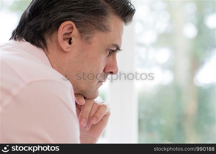 Profile View Of Worried Mature Man At Home