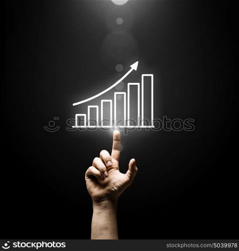 Profit chart. Human hand pointing with finger at growing graph
