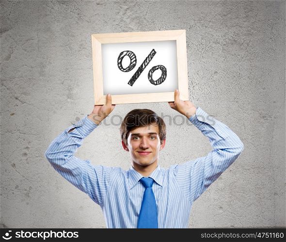 Profit concept. Handsome businessman holding frame with percentage symbol
