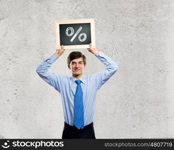 Profit concept. Handsome businessman holding frame with percentage symbol