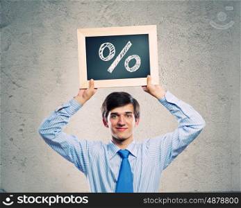 Profit concept. Handsome businessman holding frame with percentage symbol