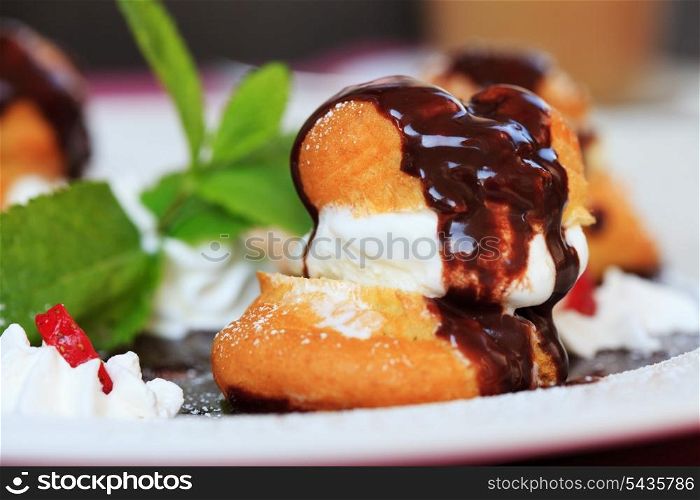 profiteroles with ice cream chocolate on plate