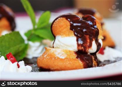 profiteroles with ice cream chocolate on plate