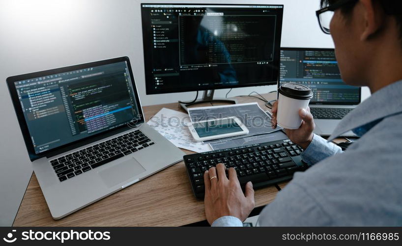 Programmer Typing Code on desktop computer, Developing programming and coding technologies concept