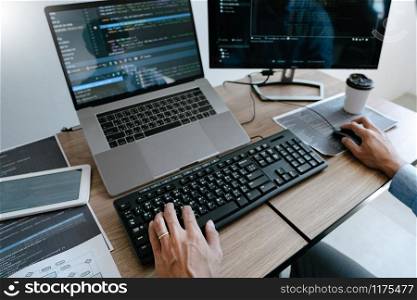 Programmer Typing Code on desktop computer, Developing programming and coding technologies concept