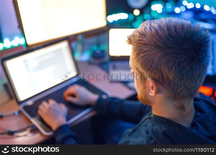 Programmer using laptop and PC, information technology. IT-manager at his workplace, professional coding and encryption, network security