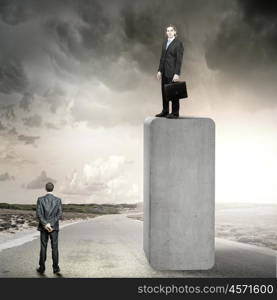 Progress in business. Businessman standing on bar and looking down at colleague