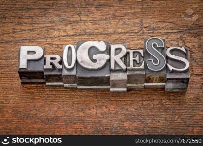 progress word in mixed vintage metal type printing blocks over grunge wood
