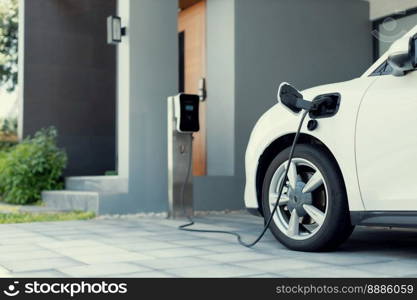 Progressive concept of EV car and home charging station powered by sustainable and clean energy with zero CO2 emission for green environmental. Charging point at residential area for electric vehicle.. Progressive concept of EV car and home charging station in residential area.