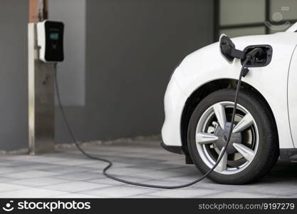 Progressive concept of EV car and home charging station powered by sustainable and clean energy with zero CO2 emission for green environmental. Charging point at residential area for electric vehicle.. Progressive concept of EV car and home charging station in residential area.