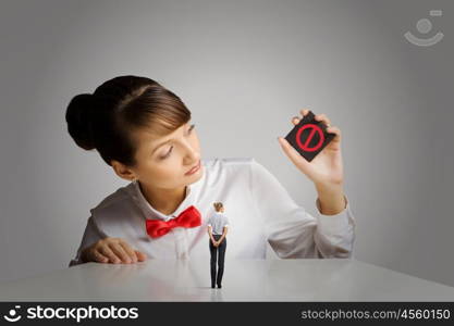 Prohibition concept. Young woman holding card with prohibition sign