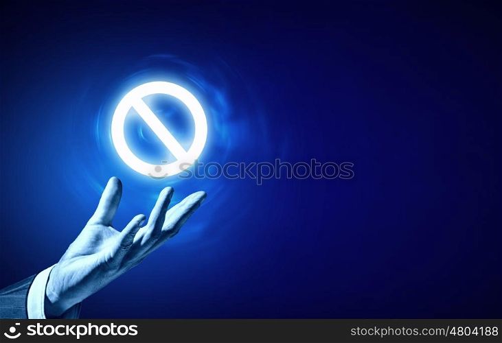 Prohibition icon. Person hand holding digital prohibition sign on blue background