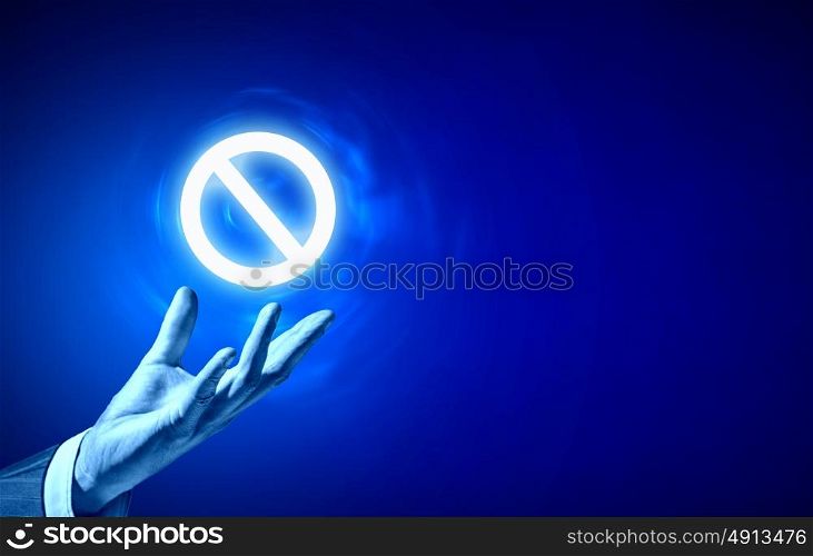 Prohibition icon. Person hand holding digital prohibition sign on blue background