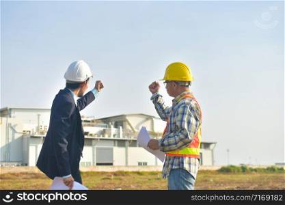 Project manager and Engineer construction holding hand success project,Production manager and Engineer holding hand success project factory background
