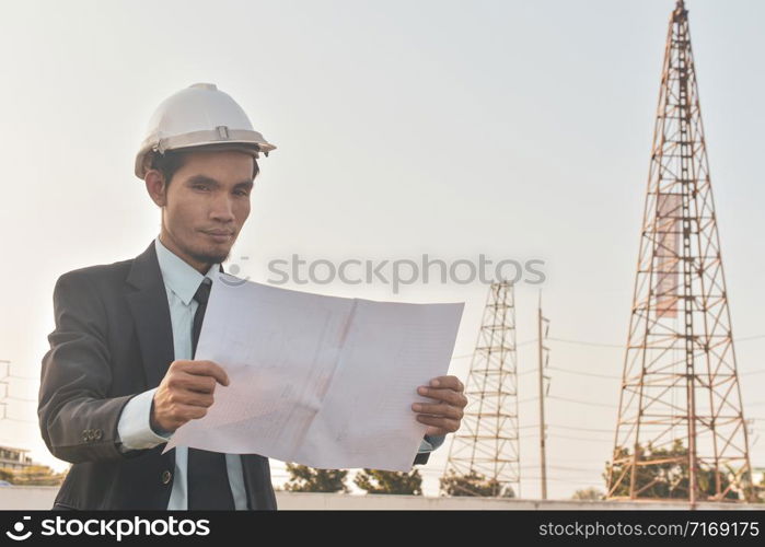 Project manager holding paper blueprint inspection estate construction building project