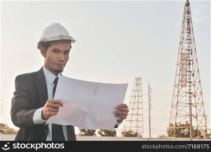 Project manager holding paper blueprint inspection estate construction building project