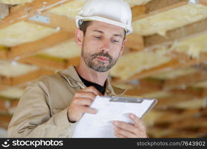 project manager making notes on clipboard