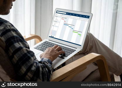 Project planning software for modish business project management on the computer screen showing timeline chart of the team project. Project planning software for modish business project management