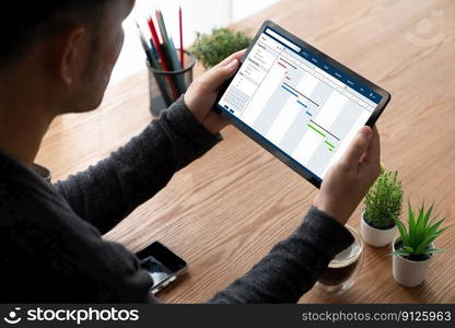 Project planning software for modish business project management on the computer screen showing timeline chart of the team project. Project planning software for modish business project management