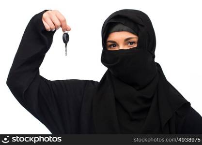property and people concept - muslim woman in hijab with car key over white background. muslim woman in hijab with car key over white