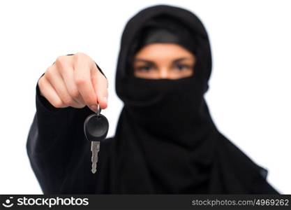 property and people concept - muslim woman in hijab with car key over white background. muslim woman in hijab with car key over white
