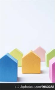 Property Concept With Coloured Model Houses On White Background