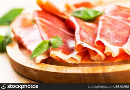 prosciutto ham on wooden table