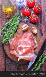 prosciutto on board and on a table