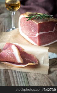 Prosciutto with fresh rosemary on the wooden board