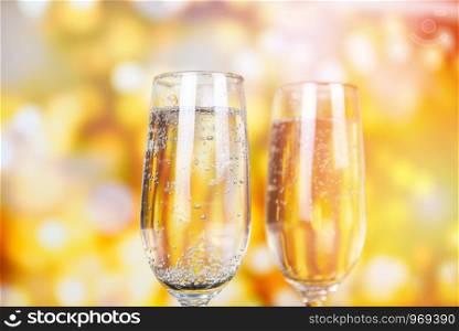 prosecco glass holiday drinks like themed party and holiday celebration concept with Champagne glasses for winter holidays decorated christmas lights bokeh gold background