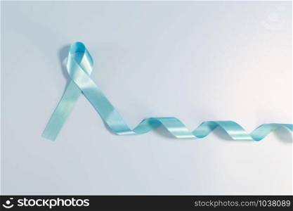 Prostate cancer awareness campaign concept, Men&rsquo;s health concept. light blue ribbon long tail on blue background. Symbol for support men who living with cancer