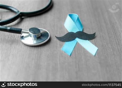 Prostate Cancer Awareness, light Blue Ribbon with stethoscope for supporting people living and illness. Men Healthcare and World cancer day concept