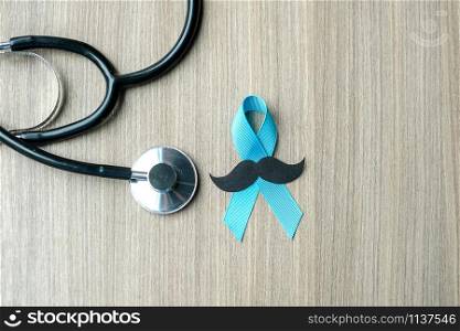 Prostate Cancer Awareness, light Blue Ribbon with stethoscope for supporting people living and illness. Men Healthcare and World cancer day concept