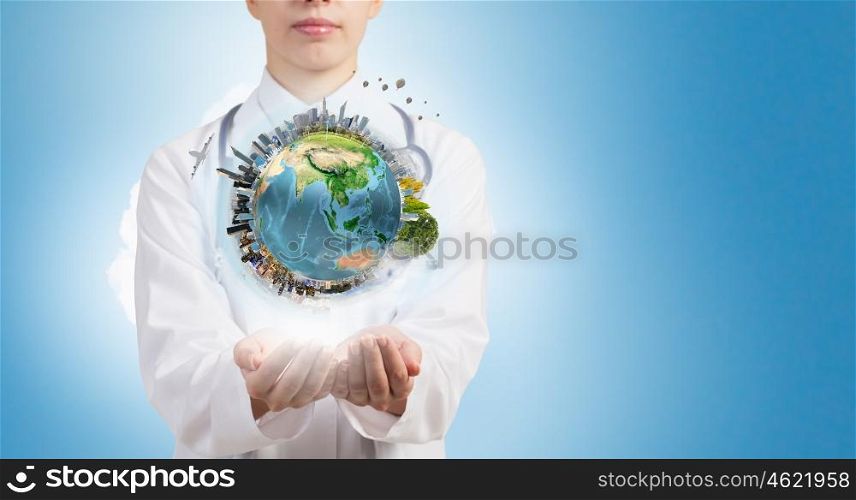 Protect life. Close up of female doctor holding Earth planet in hands. Elements of this image are furnished by NASA
