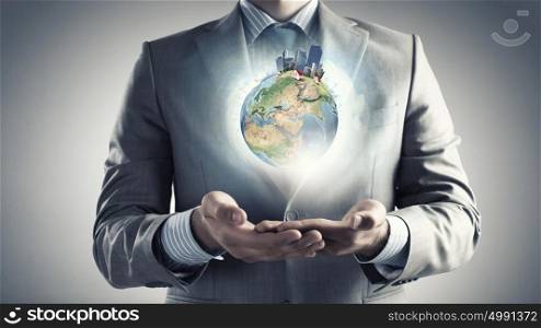 Protect life. Hands of businessman holding earth planet. Elements of this image are furnished by NASA
