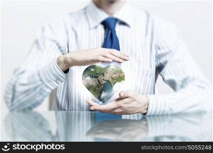 Protect life on Earth planet. Businessman hands holding heart shaped Earth planet. Elements of this image are furnished by NASA