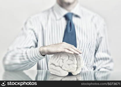 Protect mental health. Hands of man holding with care human brain