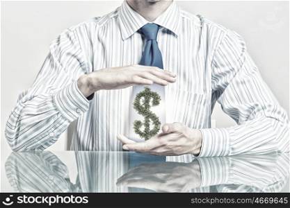Protect money investments. Hands of businessman protecting green dollar symbol