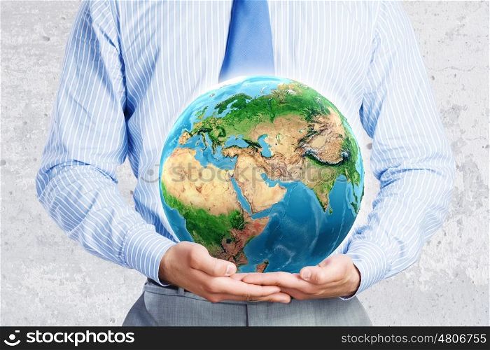 Protect our home. Close up of businessman holding Earth planet in palms. Elements of this image are furnished by NASA